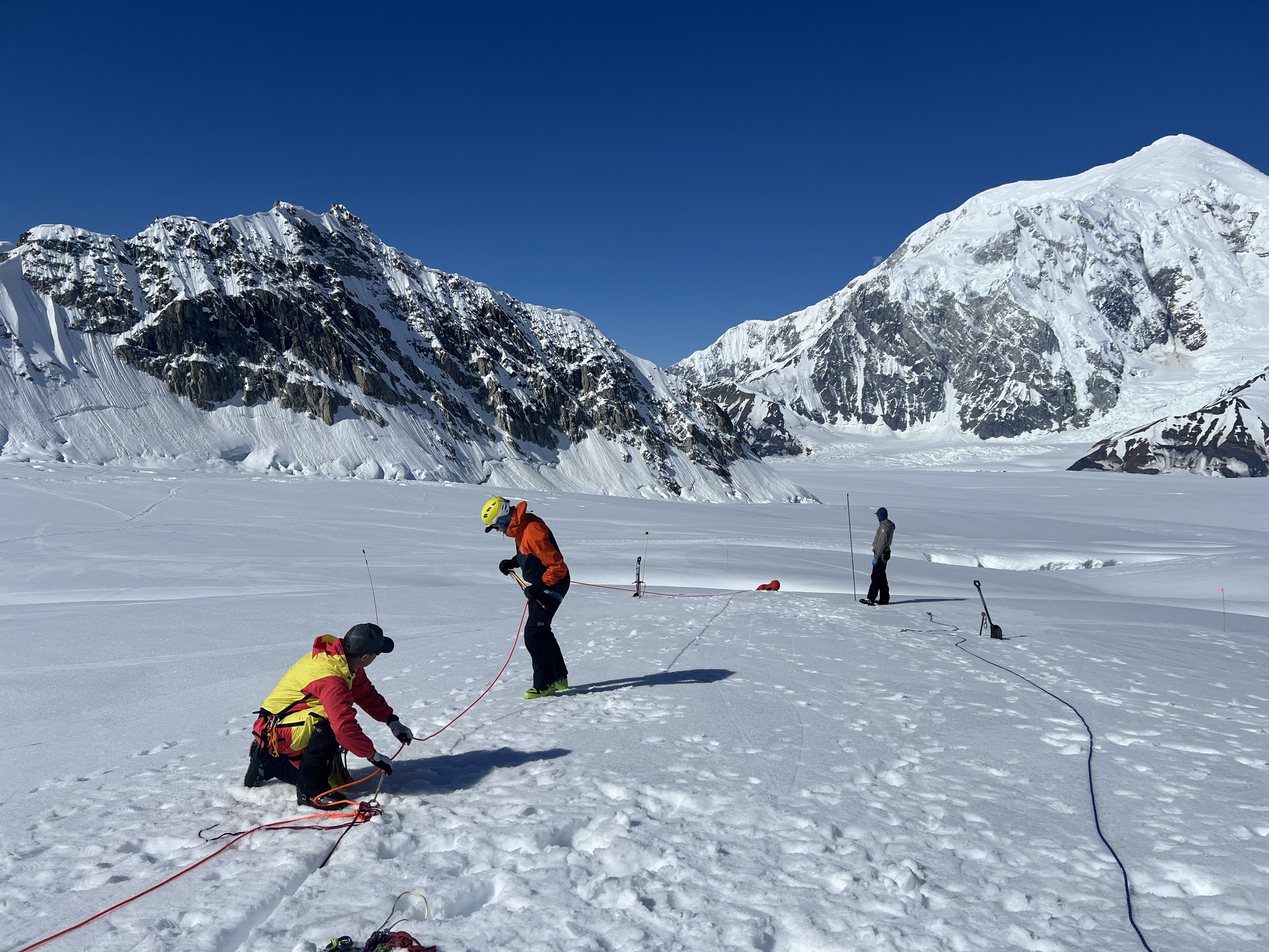 Practice makes perfect Climbers set up a pulley system on the glacier surface, with the head of a fourth climb starting to disappear into a crevasse