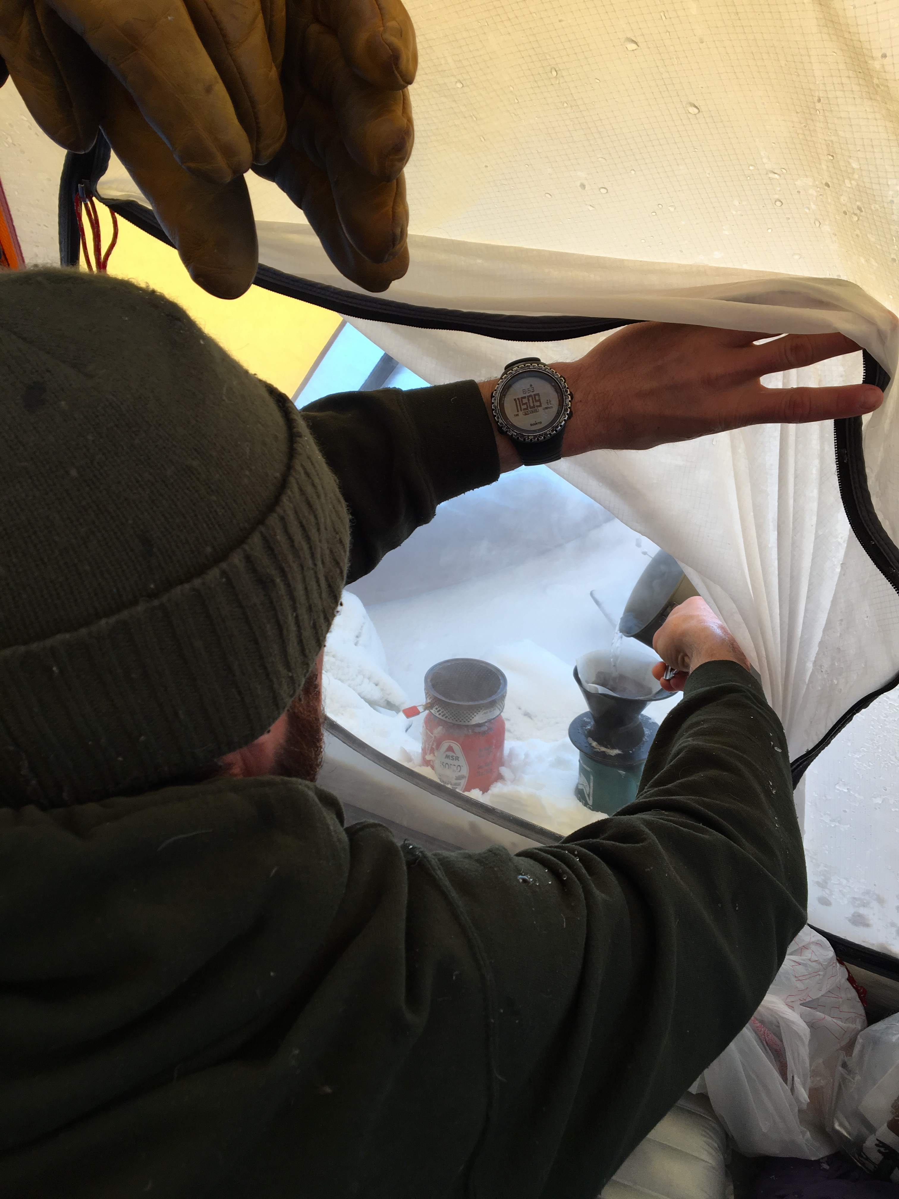 A climber makes a cup of coffee