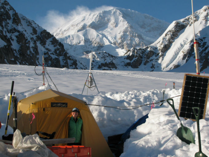 Volunteer poking head out of NPS Basecamp Tent