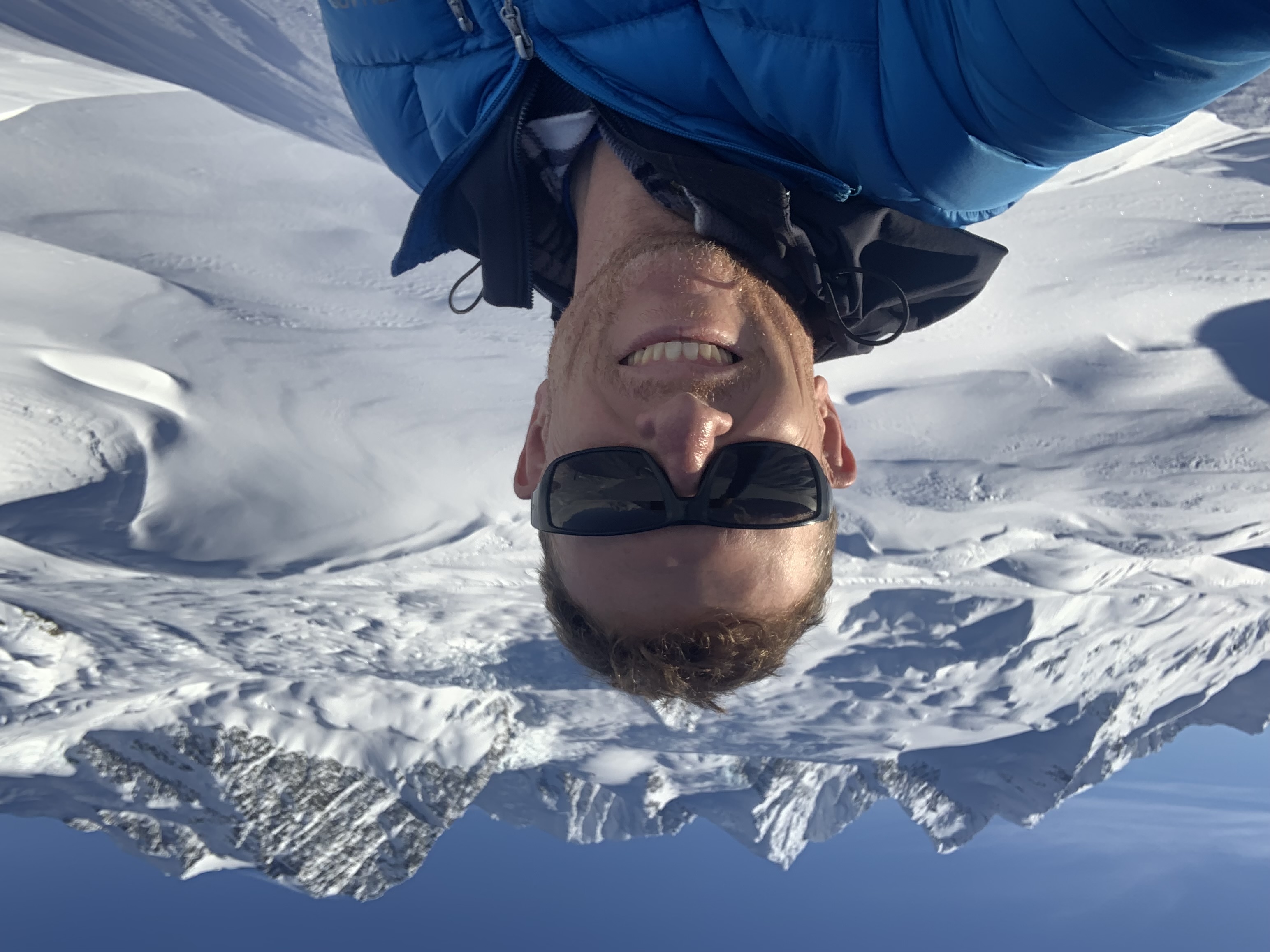 Eric Ridington, TEMSCO pilot Man with a snowy backdrop smiles at the camera