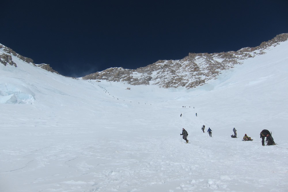 A long line of climbers ascend the fixed lines during the height of the season