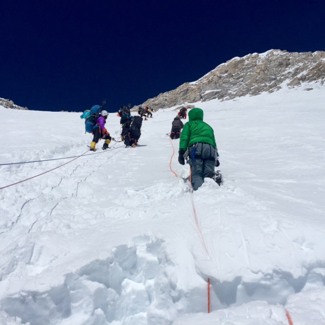 Roped climbers on a steep headwall