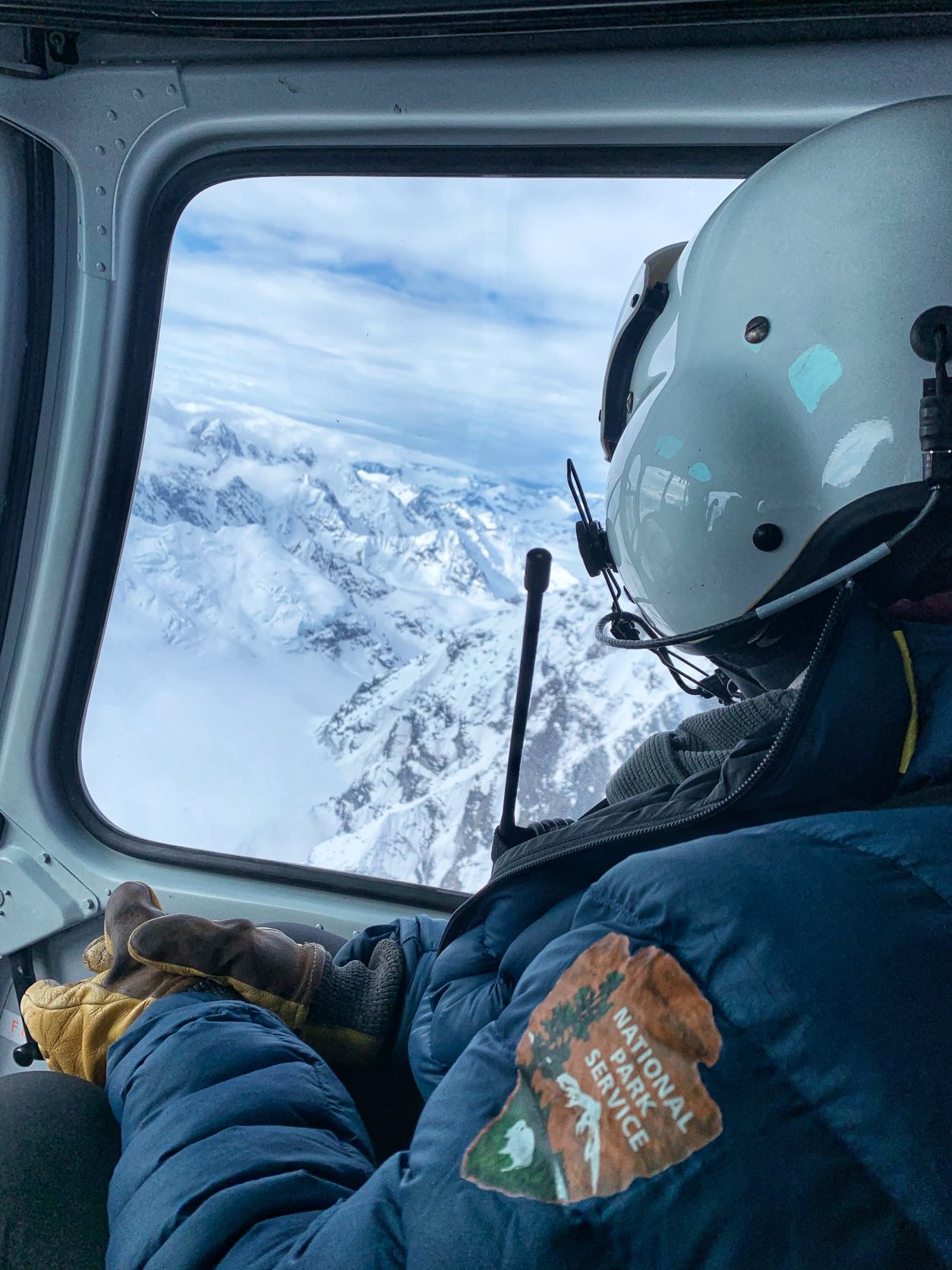 Ranger peers out of a helicopter in flight