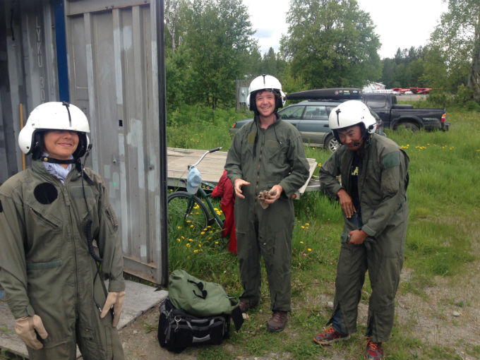 Three volunteers in flight suits and helmets Three volunteers in flight suits and helmets