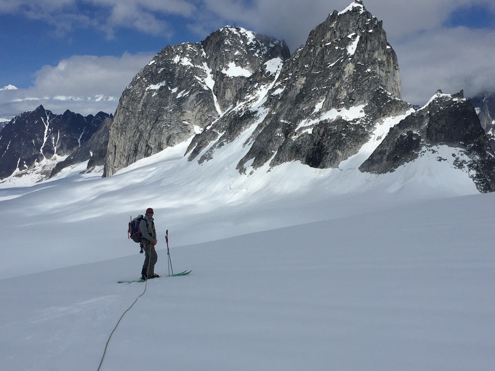 Skier with the Throne and Trolls rock features in the backdrop