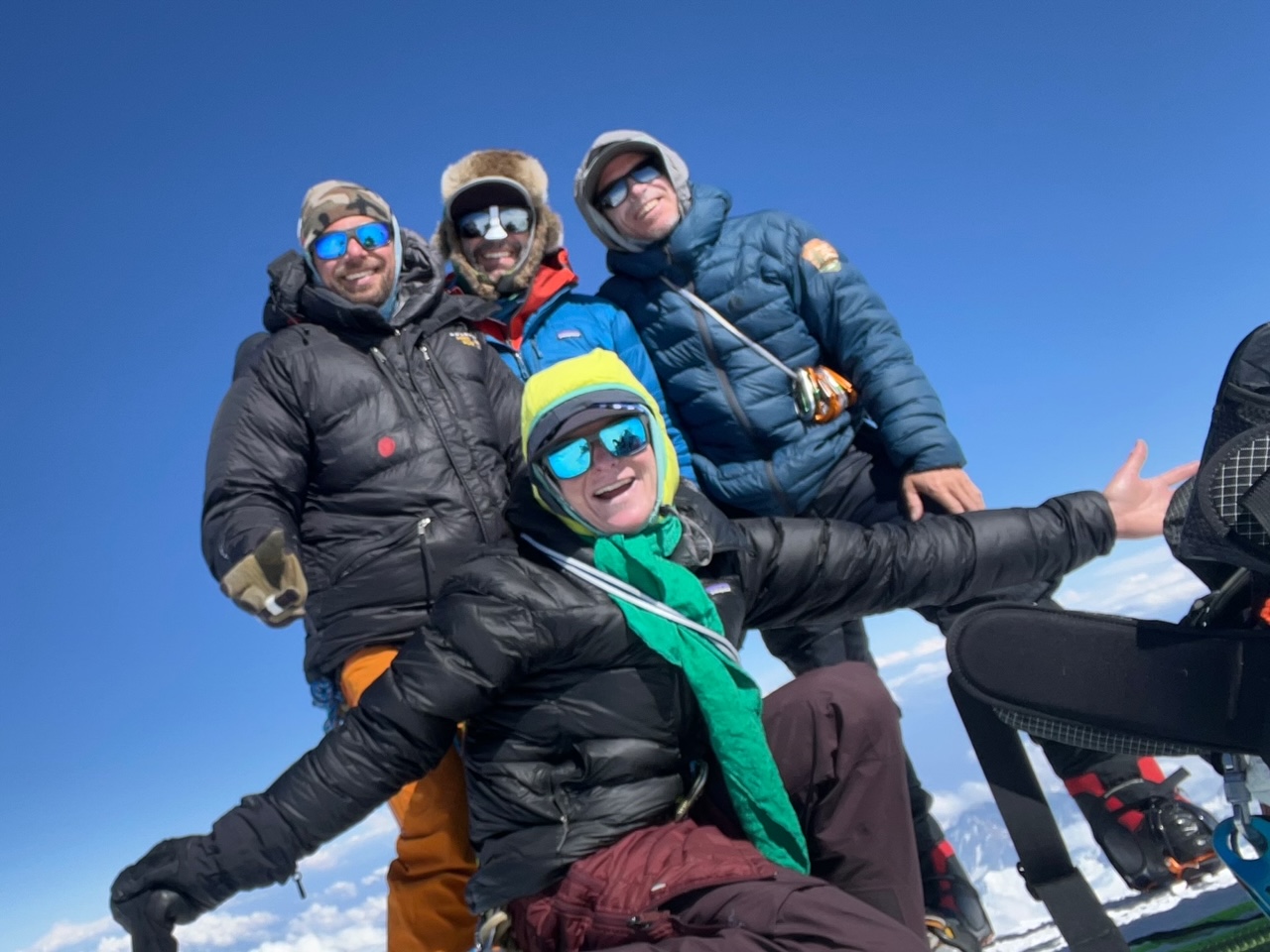 Dream Team on the summit Four cold, smiling faces standing on the summit of North America's highest peak