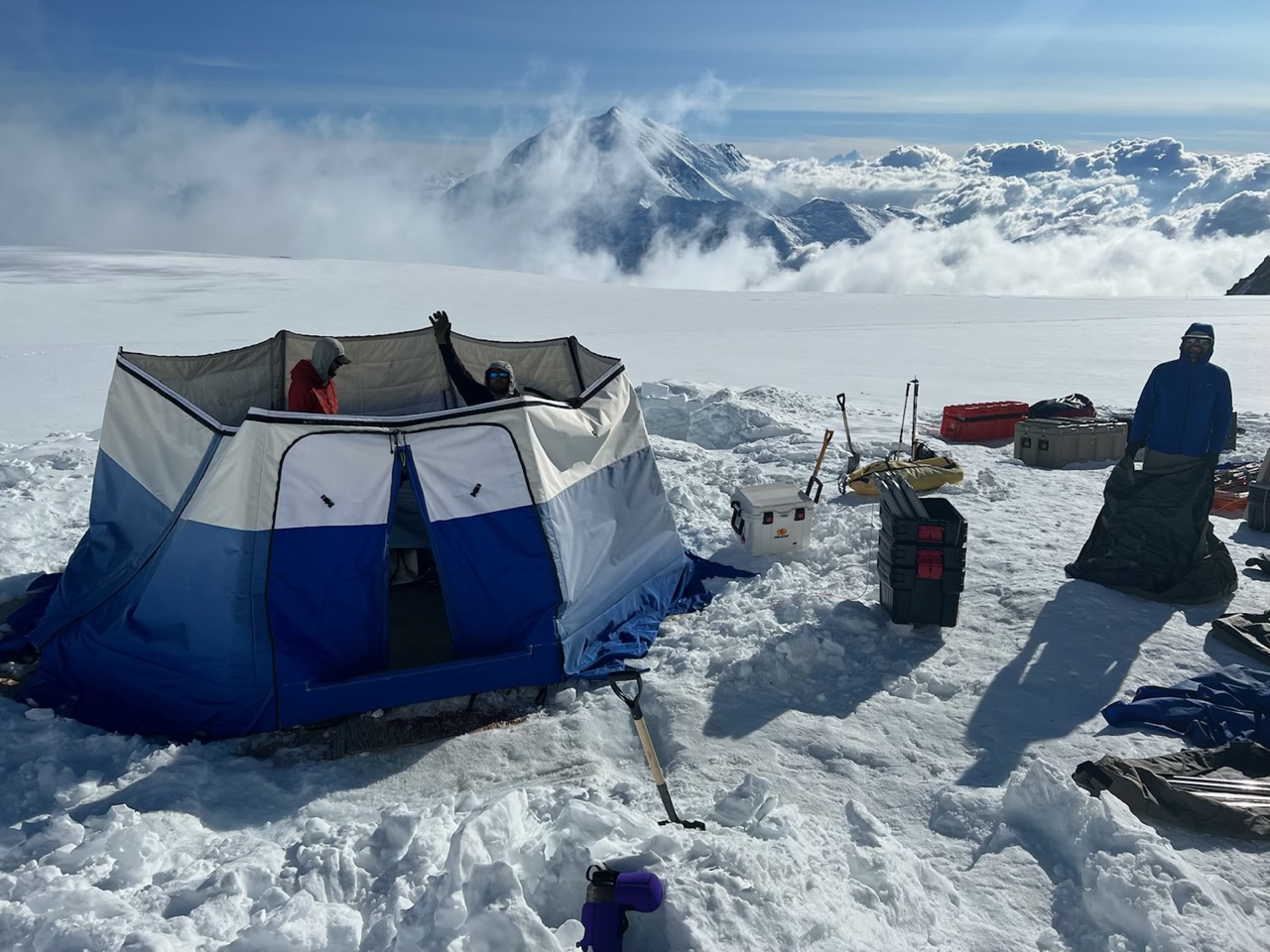 Packing up 14 camp A ranger patrol disassembles a blue tent on a glacier