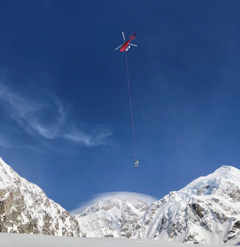 Slingload NPS helicopter slinging the radio repeater to Mount Crosson