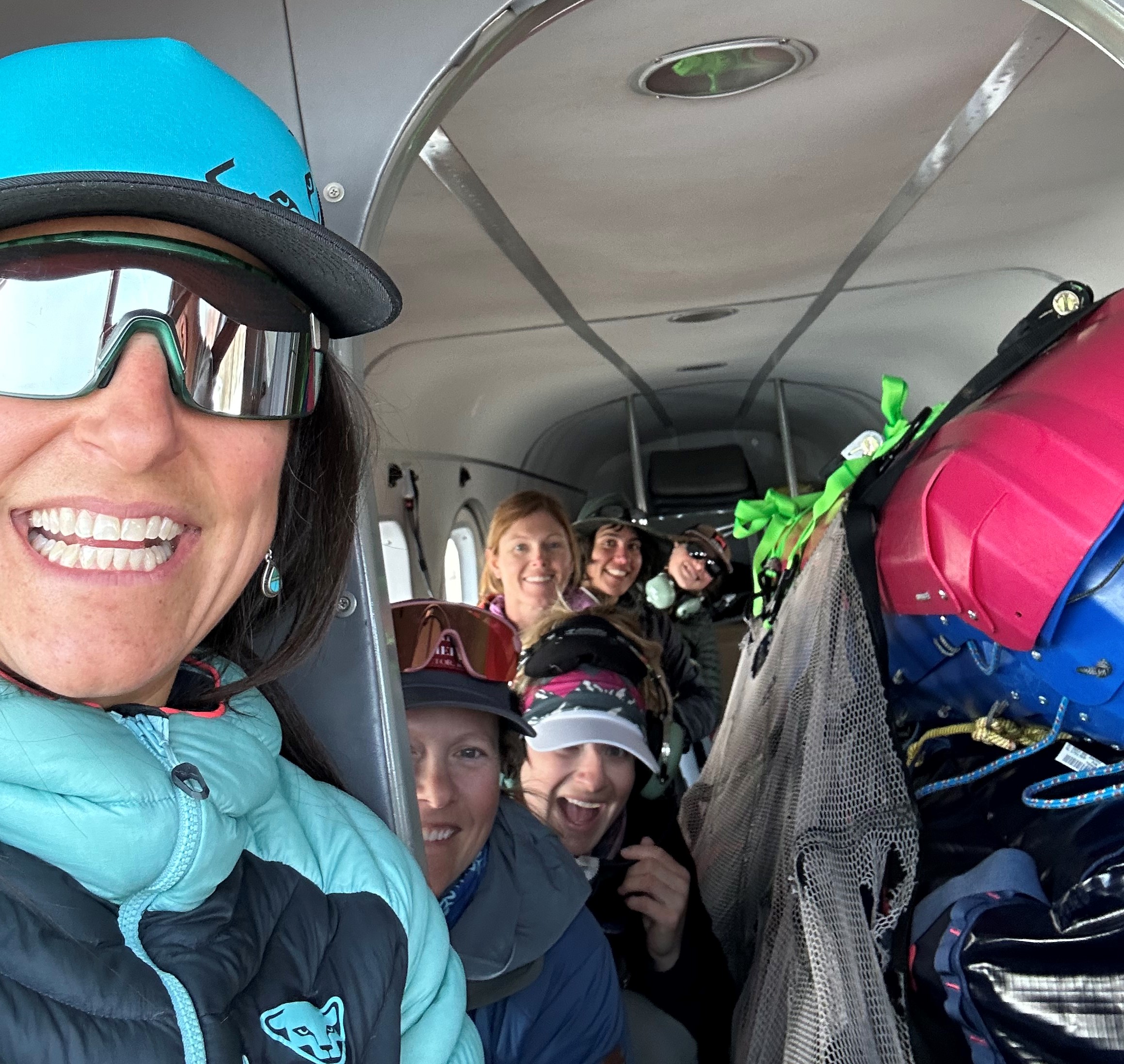 Inbound! Selfie view of six smiling women in a small aircraft