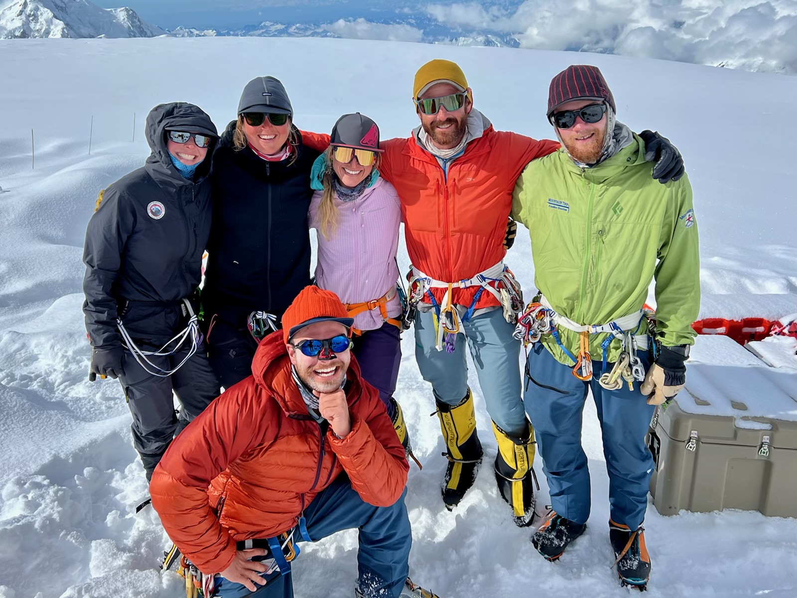 Jake's patrol Six colorful mountaineers pose on a snowy glacier