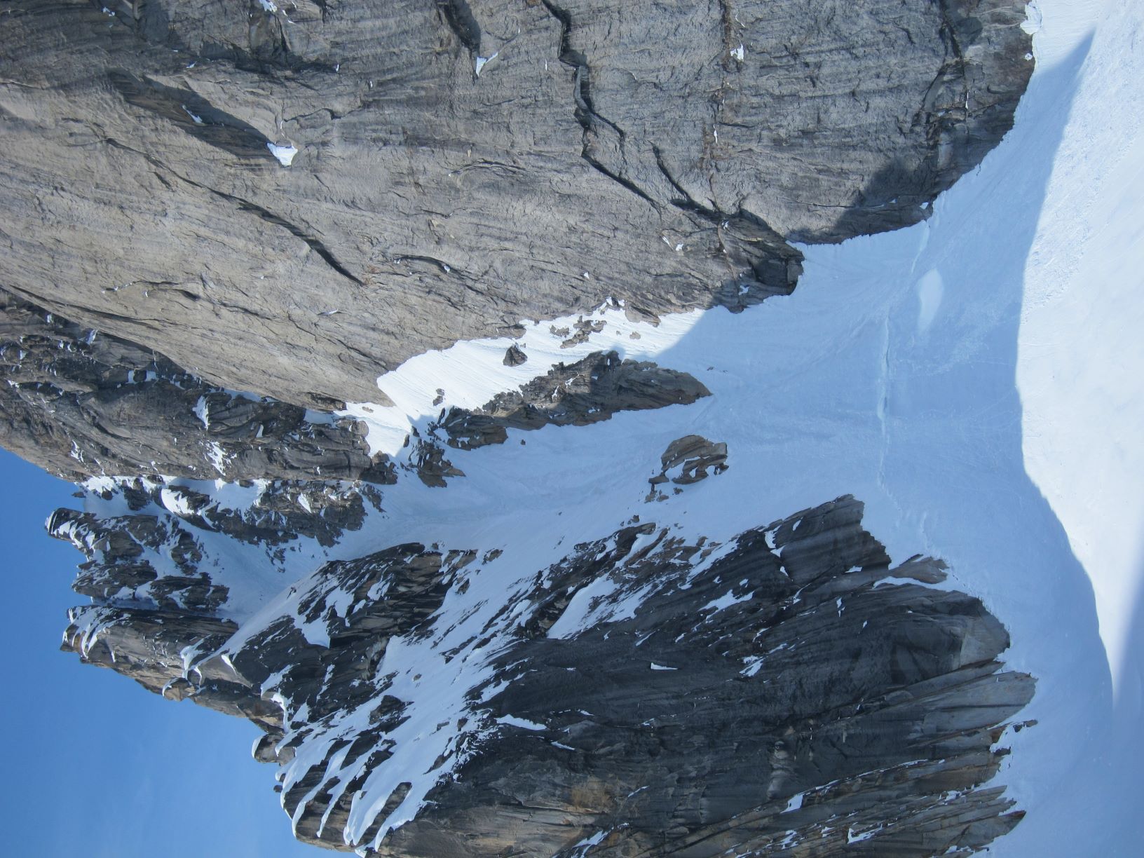 Snow covered chute adjacent to granite wall