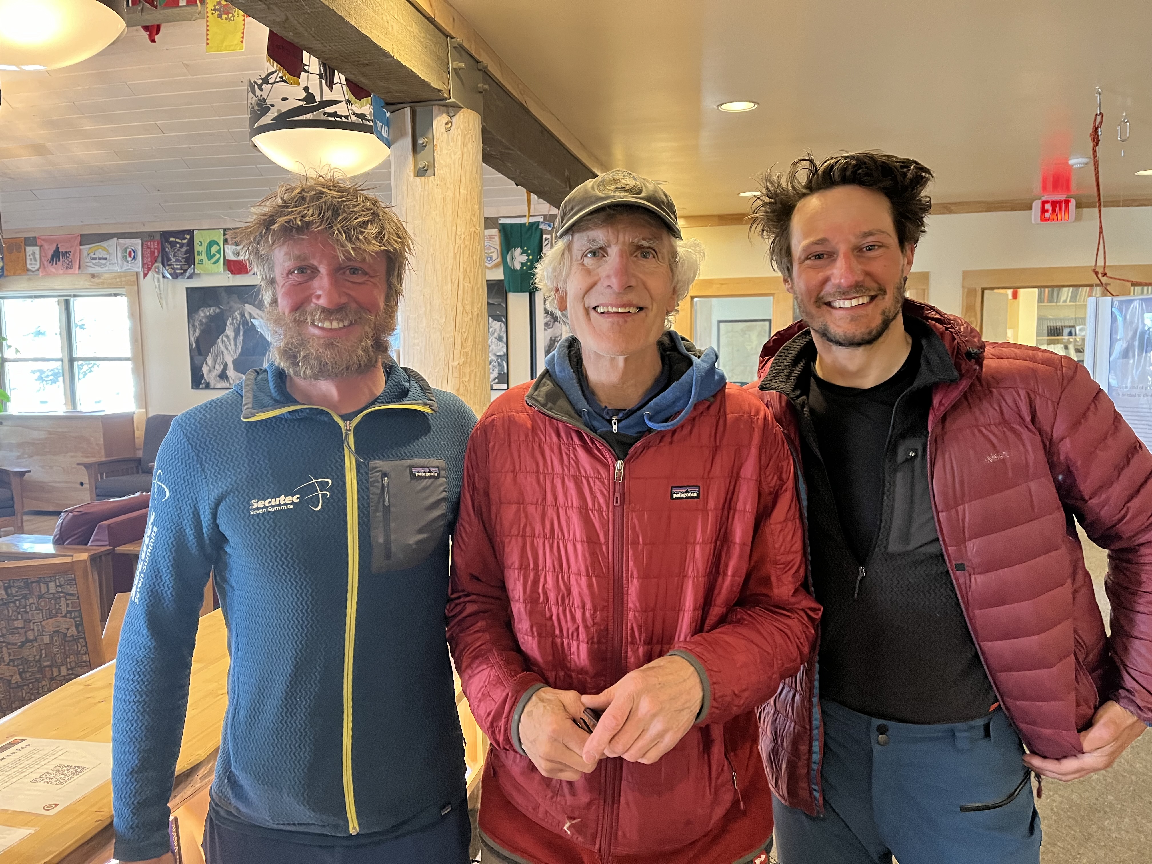 The Belgians and their Alaskan Mentor Closeup of three smiling men in a ranger station