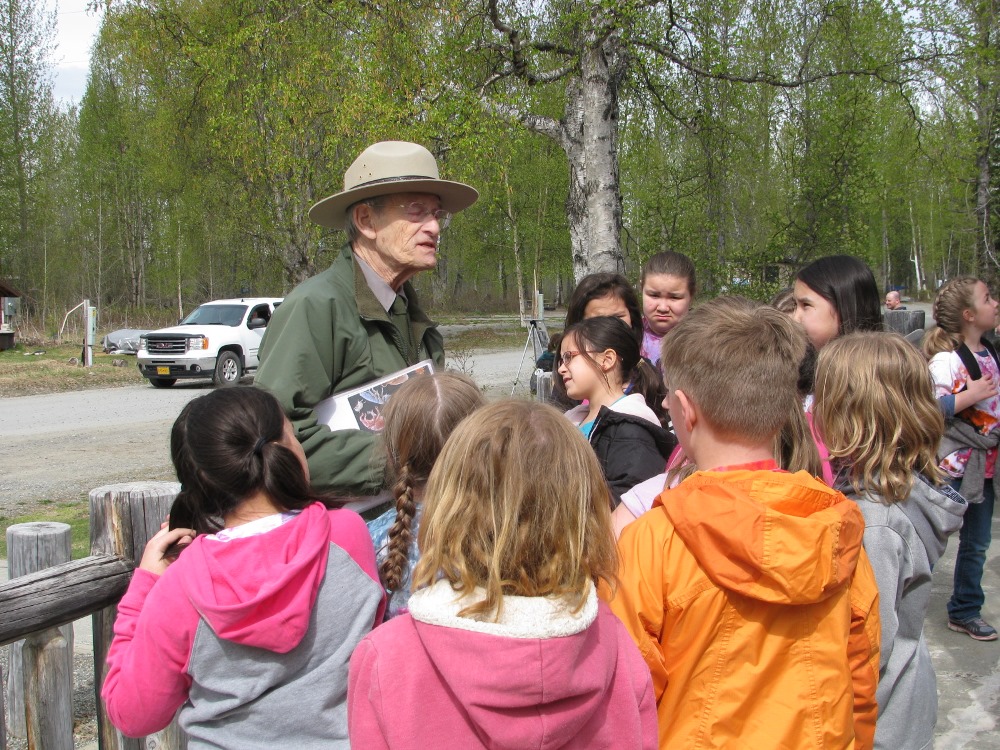 Ranger surrounded by schoolchildren