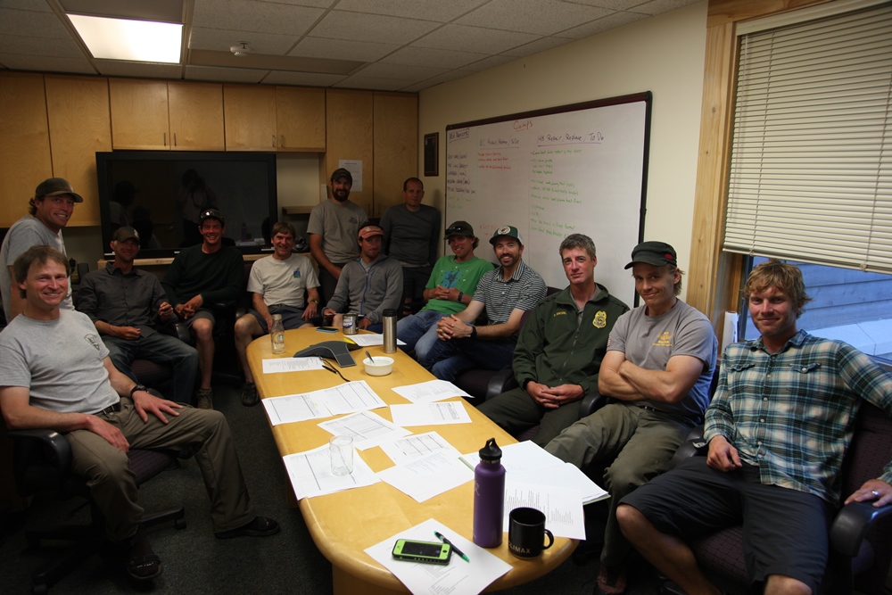 Mountaineering rangers and helicopter crew convene for the final morning meeting of the 2016 season