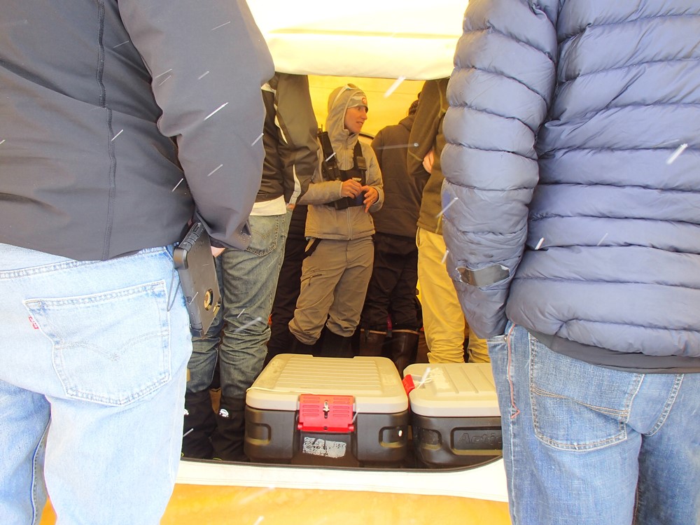 Ranger Melis hosts a crowd of tourists in the NPS tent at basecamp