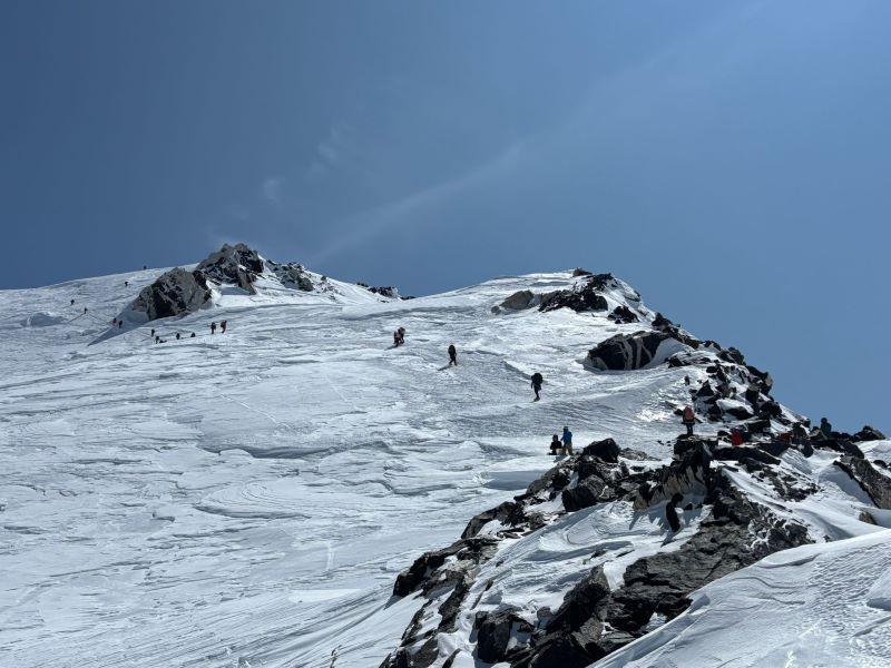 Mountain Conditions a line of mountaineering rangers climbing near a ridge