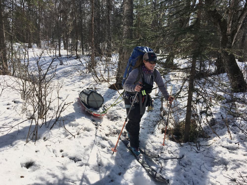 Ranger on skis pulling a sled of rescue gear