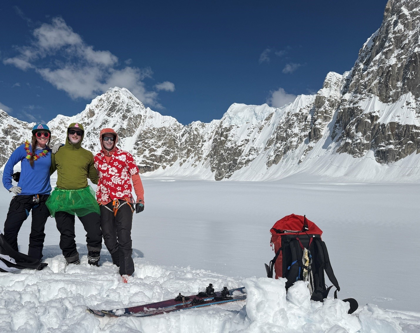 BC Patrol #3 3 rangers linked arm in arm pose in front of a mountain ridgeline and a blue sky