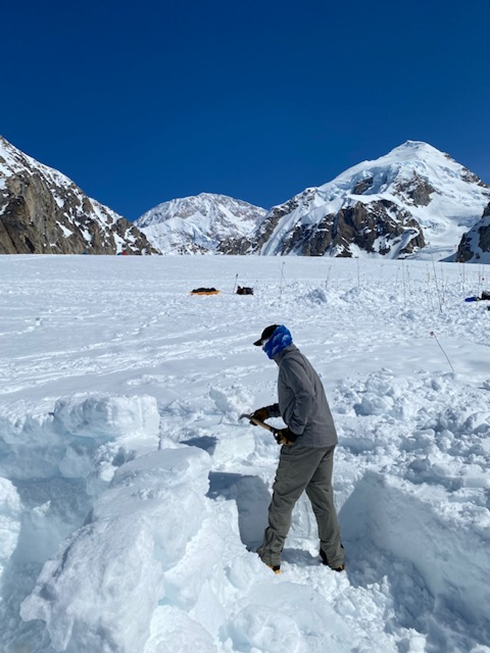 Rearranging snow on the Kahiltna Glacier A volunteer shovels or 'rearranges' snow on a glacier