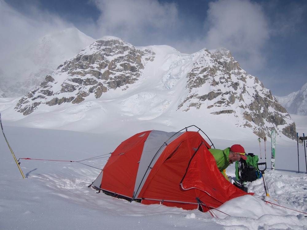 Ranger emerging from tent on a glacier Ranger emerging from tent on a glacier