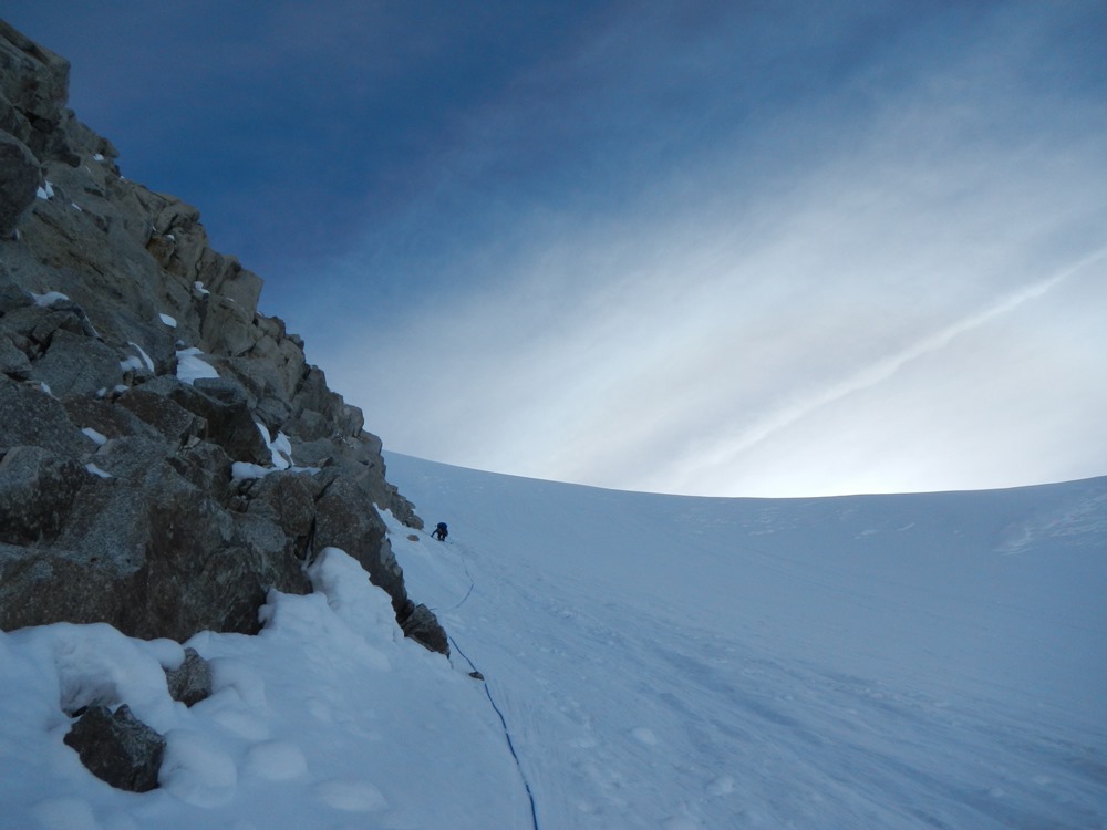 Roped climber ascending a couloir