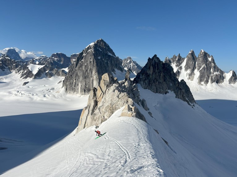 Skiing past the Munchkin A ranger skies past a mountain peak