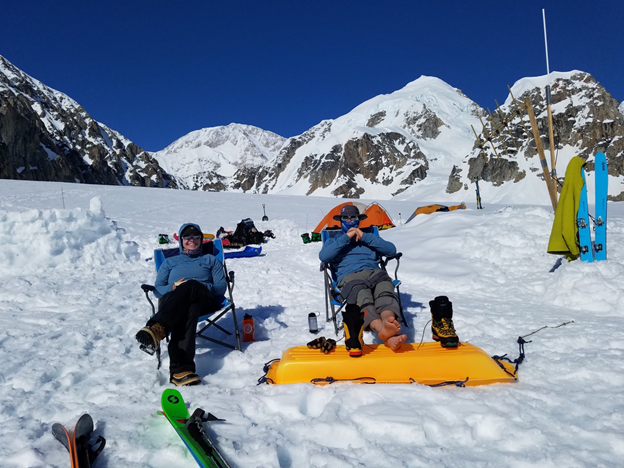 Two mountaineers enjoy some sun at basecamp