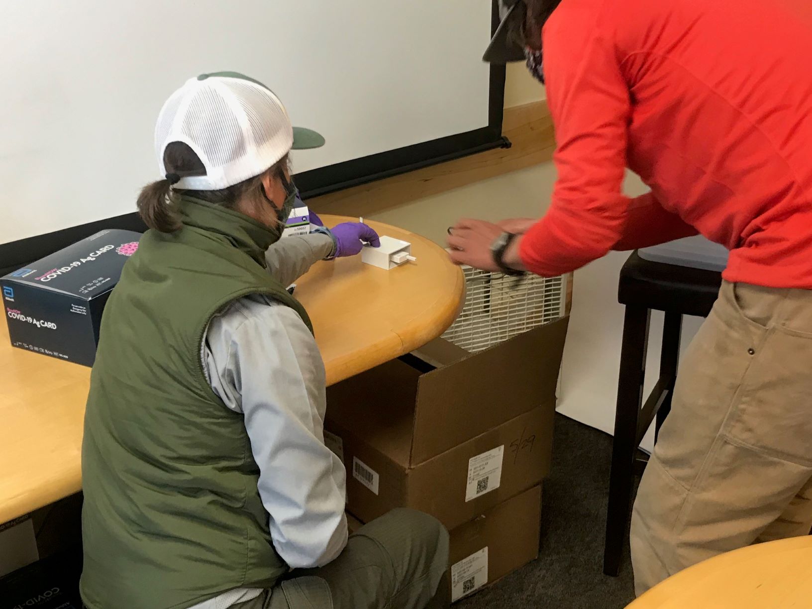 Climber inserts swab into the testing unit for instant results