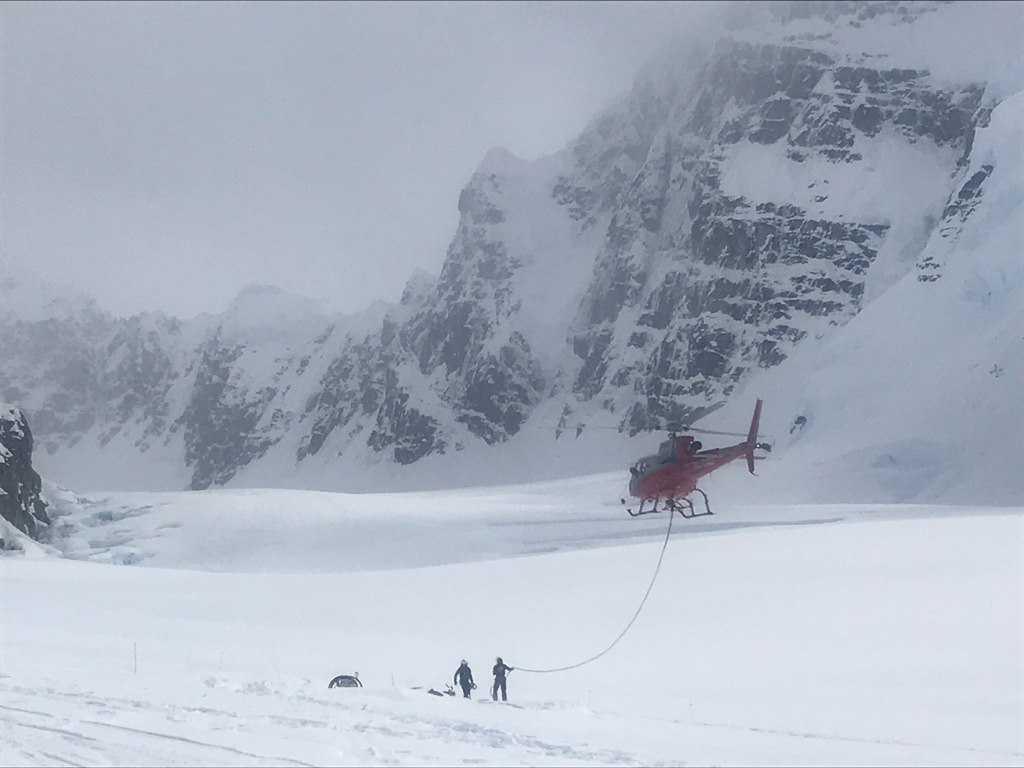 A ranger with short-haul rope in hand appears to be taking the park helicopter for a walk