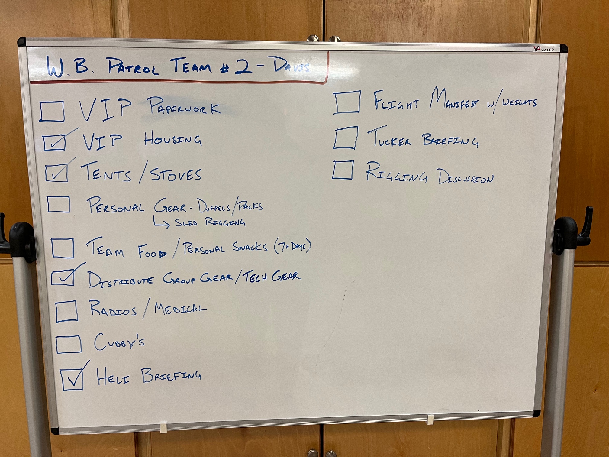 View of an expedition checklist handwritten on a dry erase board