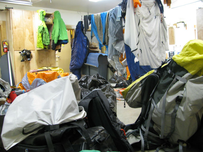 A garage bay filled with hanging tents and camp gear