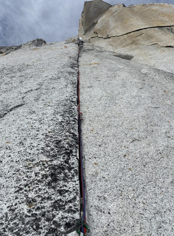 Upper section of the 510a crack A ranger climbs up a cracked rock face