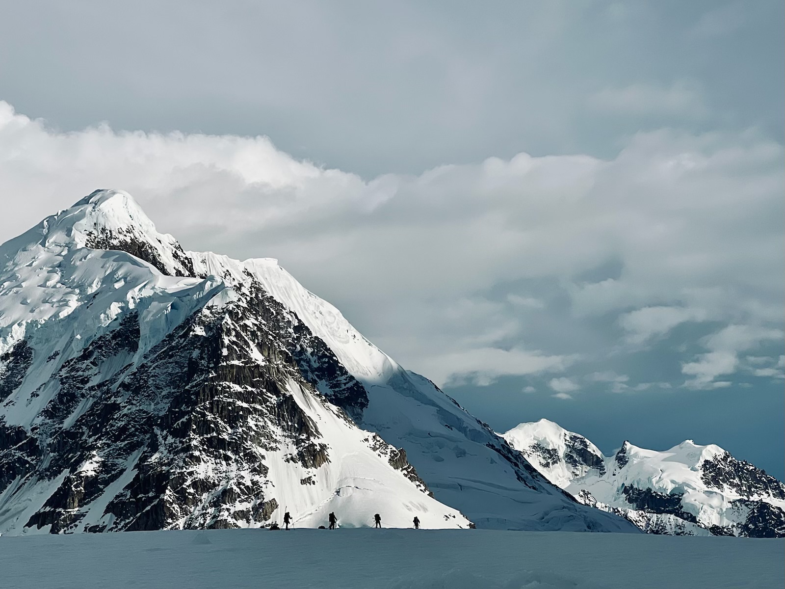 Mount Francis Silhouettes of four mountaineers contrasted in the snowy face of Mount Francis