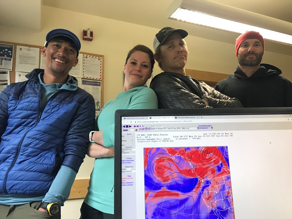 Westman 14K patrol Four patrol members surround a computer screen showing weather mapping