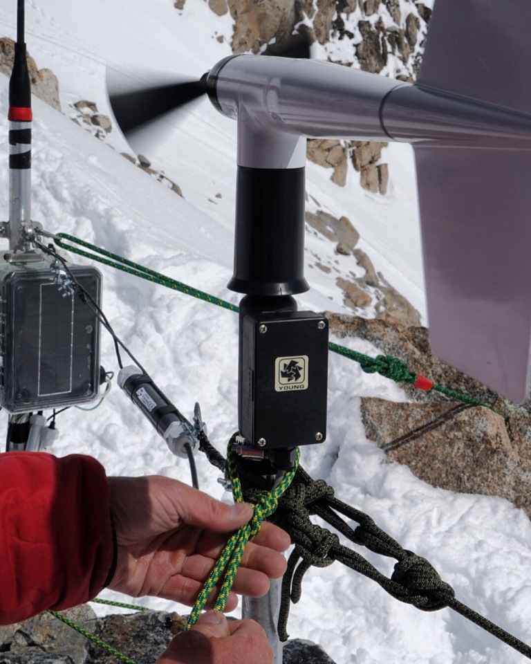 Ranger making final touches on anchoring system for weather station