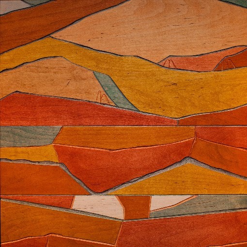stylized mountains carved and painted on a piece of wood