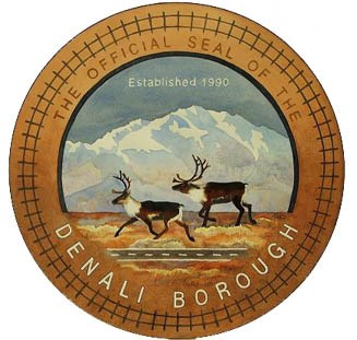 Denali Borough seal two caribou running in front of mountain