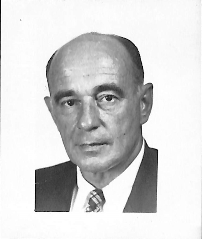 Ilia A Tolstoy_Explorer's Club portrait style photo of a middle age man in a suit