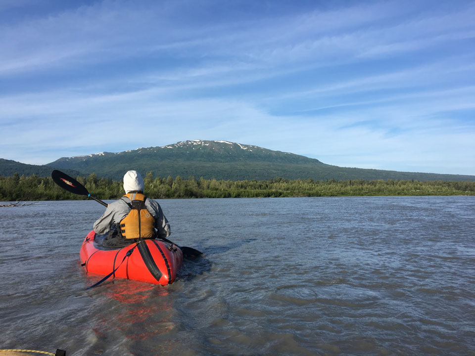 kichatna-3 a man floating down a river in a pack raft