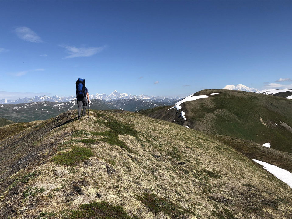 man standing on a hill top