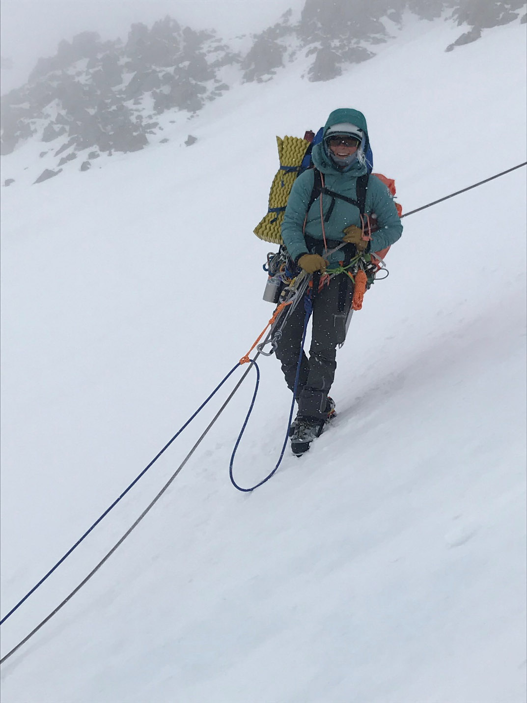 melis 1 female mountaineer attached to ropes on a steep icy slope
