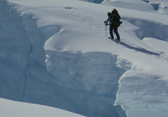 Mountaineer near a large crevasse