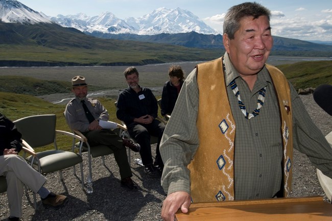 Alaska Native Chief Mitch Demientieff of Nenana tells the Legend of Denali at the Eielson Visitor Center, where Denali looms in the background.