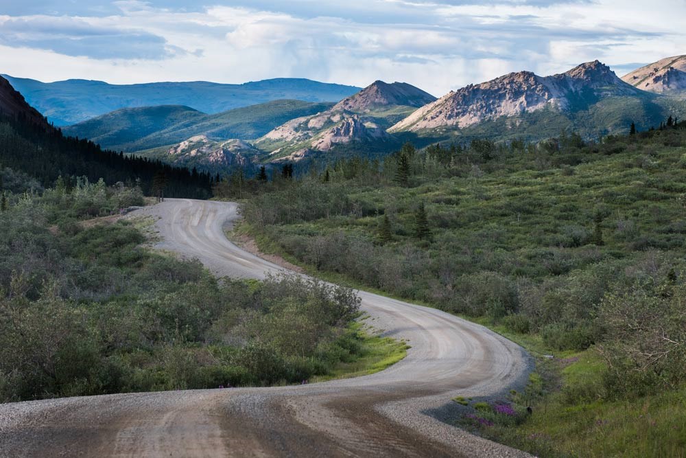 a dirt road winding through a mountainous landscape a dirt road winding through a mountainous landscape