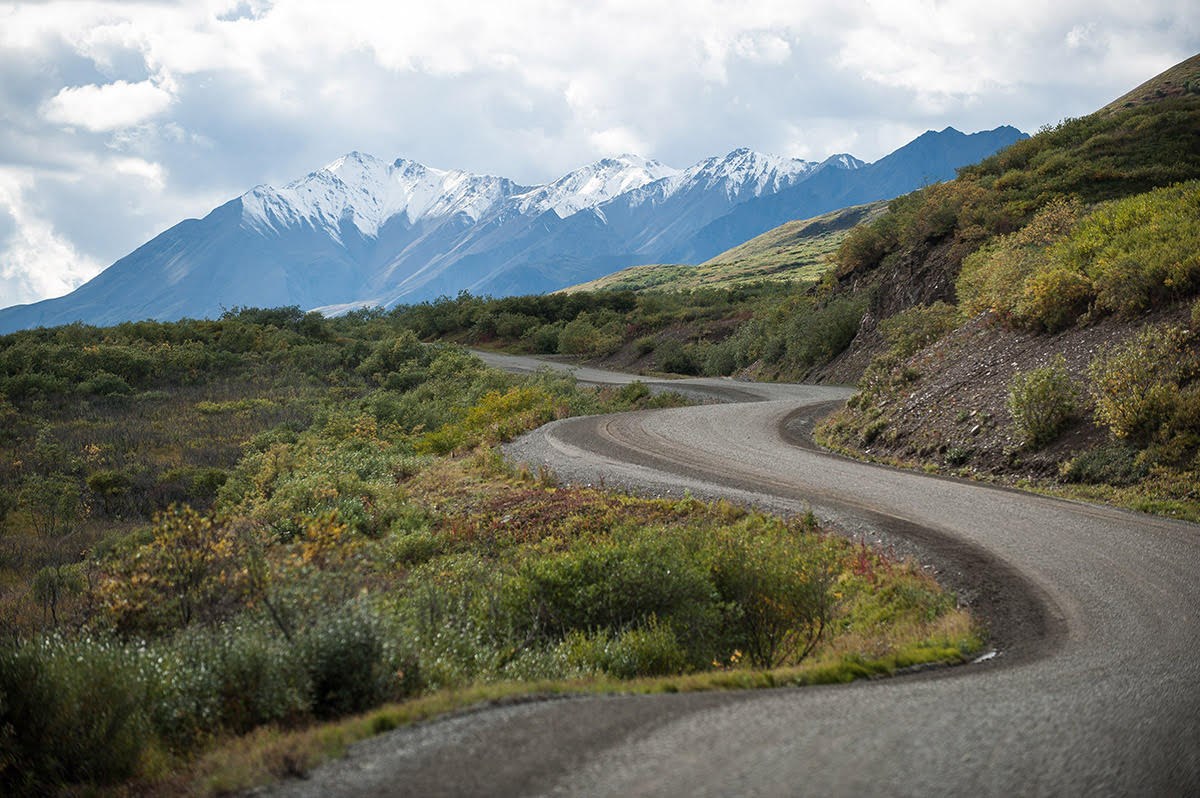 a dirt road winding through a mountainous landscape a dirt road winding through a mountainous landscape