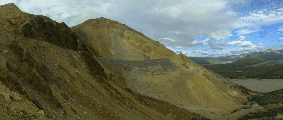 timelapse of a mountainside with a gravel road on it slowly sliding downhill
