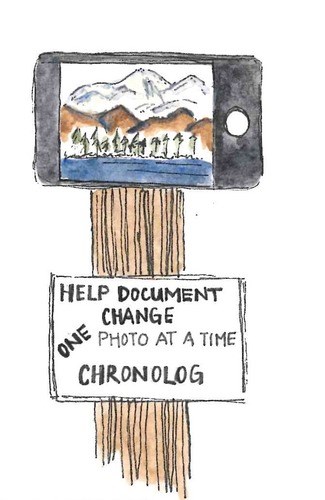 A smart phone with a camera app open sitting on a post