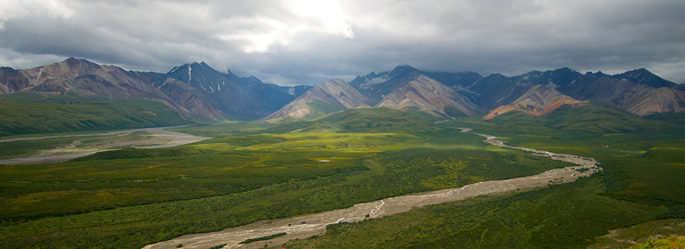 a braided river flows across a plain with mountains in the background a braided river flows across a plain with mountains in the background