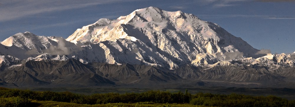 snow covered Denali towers over the surrounding landscape snow covered Denali towers over the surrounding landscape