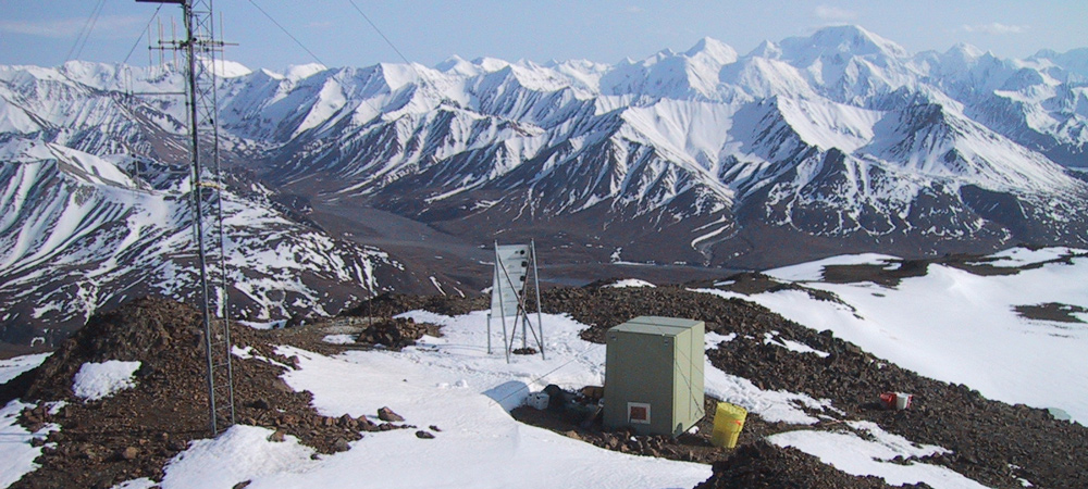 an earthquake station sits on a snowy mountainside an earthquake station sits on a snowy mountainside